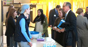 Medfield High School volunteers welcome attendees at the Candidate Forum.