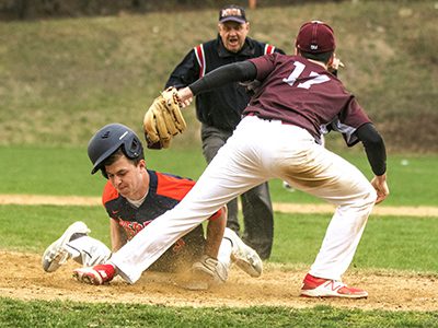Rebel senior captain Charlie Auditore (3) slides safely into third base after cracking an RBI hit in the bottom of the fourth. Photos by Tim Hoffman