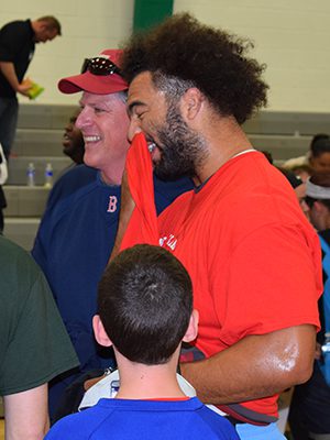 Linebacker Kyle Van Noy enjoys a laugh - and a quick breather - with some Westwood residents.  Photos by Richard McDonough