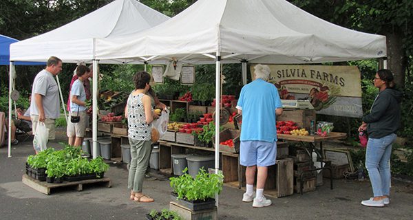 Locals tough out rain for farmers market