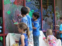 Young artists paint the library windows
