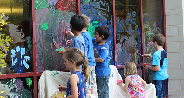 Young artists paint the library windows