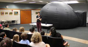 Wellesley Free Library visitors prepare for their indoor star gazing experience with the Museum of Science’s Star Lab.