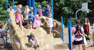 Incoming kindergarteners play on the Memorial Elementary School playground while enjoying Popsicles.  Photos by Laura Drinan.