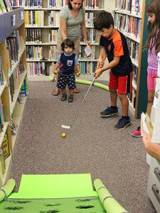 ‘Last But Not Least,’ the final hole of the Islington Branch Library’s mini golf course, required a careful, yet powerful putt to reach one of the holes on the ramp. Photos by Laura Drinan. 