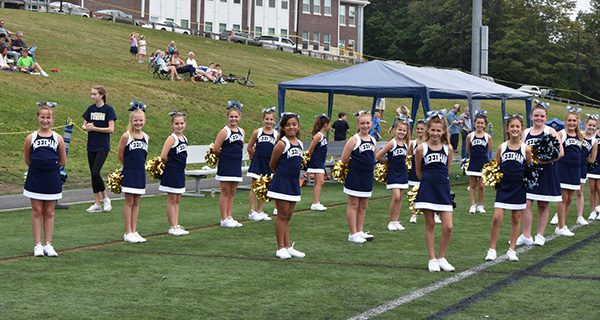 The combined fifth and sixth grade cheer squad stands proud at the first home game.