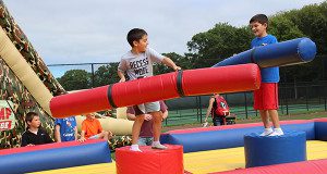 Eight- and nine-year-old brothers, Kyle and Max O’Shea, battle on the inflatable jousting arena as they celebrate Westwood Day.