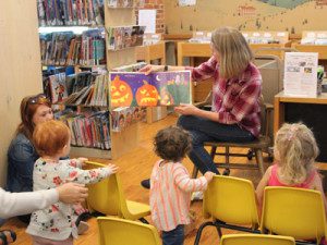 Gwenyth Swain reads a story about jack-o-lanterns at the weekly ‘Stay and Play Storytime’ at the Sherborn Library.