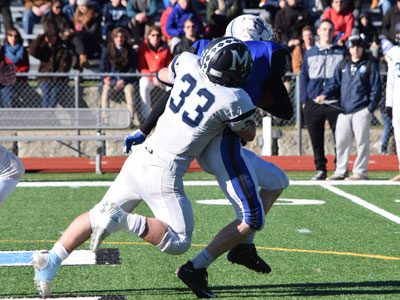 Medfield linebacker Mason Giunta (33), who had a record-breaking day on offense, attempts to haul down DS wideout Luke Fielding (8) on a slant over the middle late in the first half. 