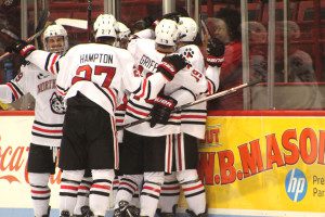 Lincoln Griffin (19) celebrates with teammates following the game-winning goal by Jeremy Davies with 2:12 remaining in the third period. 