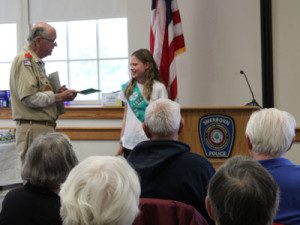 Pine Hill Elementary student, Lily Page, is presented with a token of appreciation for taking the time to read her essay on the significance of Veterans Day.