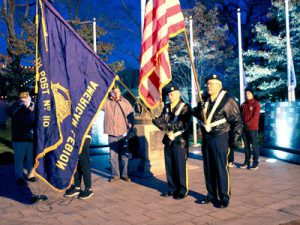 Just after dusk, the American Legion Post 110 hosts a Veterans Day ceremony at the Baxter Park memorial.