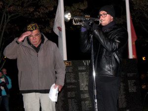  Justin Plakias, a Medfield student, performs the taps to close the Veterans Day ceremony at Baxter Park.