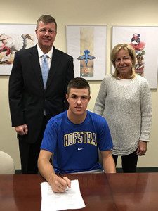 Timmy Hall (middle), who’s brother Bobby plays hockey at Babson, poses with his parents after signing his NLI to play golf at Hofstra on Wednesday and becoming the second Hall sibling to play a sport in college. 