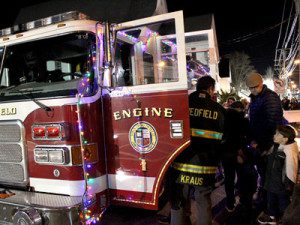 The Medfield Fire Department welcomes children aboard a decorated fire engine.