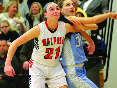 Walpole center Jill White (21) boxes out Medfield’s Arianna Tristani (30) for a second quarter rebound.  Photos by Michael Flanagan