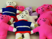 Seniors’ bear hands comfort children