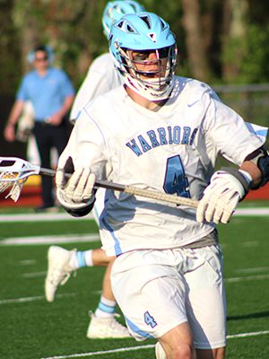 Senior captain Tom Schofield (4) moves the ball up the field for Medfield early in the first quarter. Photos by Michael Flanagan