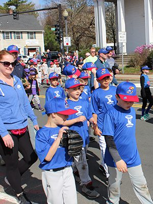 Westwood Little League players march from Hanlon Elementary School to Morrison Field to kick off the start of the season. 