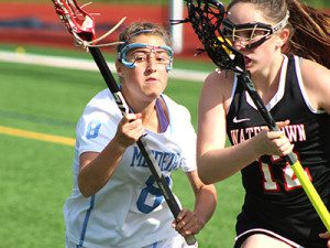 Junior attacker Lauren Sleboda (8) defends against a Watertown clear attempt late in the first half. Photos by Michael Flanagan 