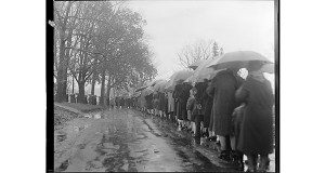 Thousands stand in the pouring rain, waiting to be cured at the grave of Father Patrick Power. Photos courtesy of the Boston Public Library, Leslie Jones Collection 