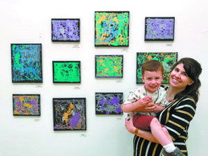 Steph Gillette and son Russel with the Green Room’s marble paintings.