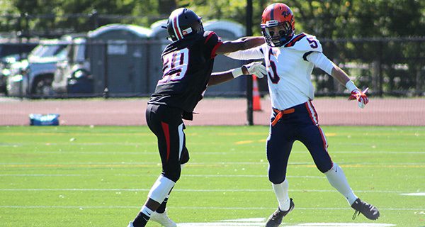 Walpole wideout Andrew White (5) becomes acquainted with a Wellesley corner in a 2017 game. White is one of several key players returning to this year’s team.  Photos by Michael Flanagan