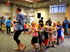 A conga line at Westwood Library is evidence of Rolie Polie Guacamole’s fun performance. Photos by Daniel Curtin