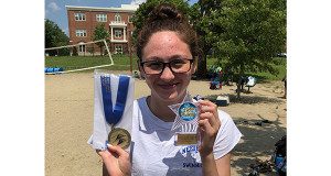 Zoei Howard poses with her first-place medal and trophy at the Jim Ehrlich Mile Swim on July 27. 