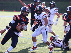 Walpole quarterback Will Jarvis (10) rushes up the sideline before diving into the end zone for the go-ahead score during the Rebels 42-35 victory over Wellesley on Saturday. 