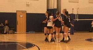 Needham comes together after winning a point in the fifth set against Walpole on Thursday night.