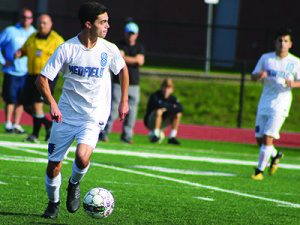 Joe Layden (8) pushes the ball across midfield late in the first half. 