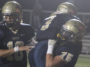 Charlie Ogletree (10) and Jake Doherty (75) mob Odahri Hibberts (3) in celebration following a second quarter touchdown. 