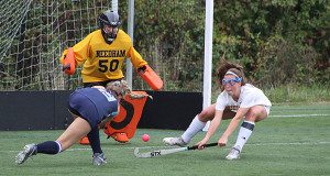 Chloe Newman (right) goes down to block a shot while Camryn Foster (50) moves in position to make the save on Walpole’s Nikki Griffin late in the first half. 