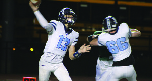 Medfield quarterback Stephen Williams (13) steps up in the pocket and fires a dime early in the first quarter. 