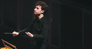 Medfield native Matthew Aucoin conducts. Aucoin was recently named a MacArthur Fellow.