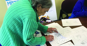Creator of the “Mind over Matter Olympics,” Ora McGuire, organizes the different dot-to-dot puzzles during the monthly competition.