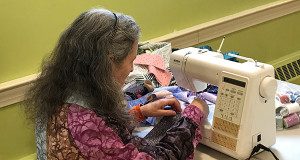 A member of the Power of the Quilt Project works on a quilt during the Quilt-A-Thon at the Unitarian Universalist Area Church.