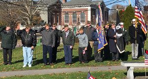 Veterans salute the flag during the national anthem during the Veterans Day ceremony at Memorial Park.
