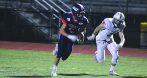 Chase Conrad (2) gets a step and dashes past a Hingham defender for a first quarter touchdown. 