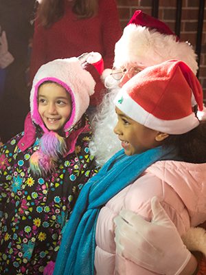 LaNisa Vasquez-Solis and Lili Shahossini pose with Santa Claus.