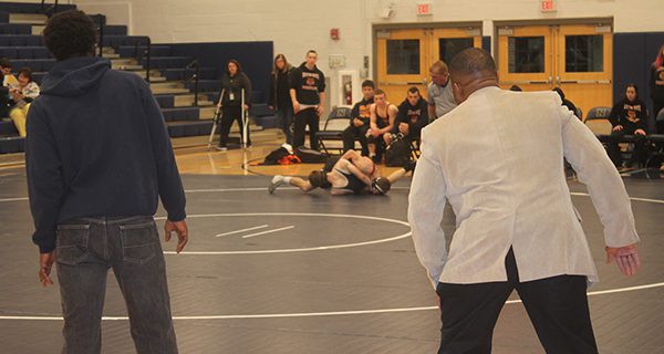 Coaches Robert Pritchett and Kamali Wilson try to use their body osmosis to prevent a pin.