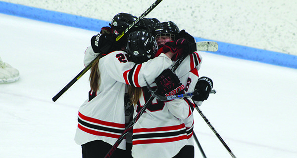 Emily Rourke is mobbed by teammates following her go-ahead goal early in the second period. Photos by Michael Flanagan