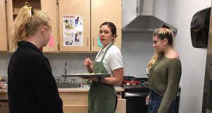 NHS School Resource Officer Adrienne Anderson teaches students how to cook.