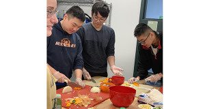 Three NHS seniors learn how to chop vegetables during Adrienne Anderson’s Basic Cooking workshop.