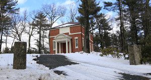 The Dover Historical Society hides behind a pile of plowed snow.