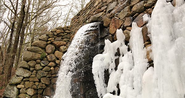 The frozen cascades of the old mill dam.