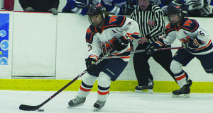 Senior captain Audra Tosone (3) carries the puck into the offensive zone on a two-on-one bid. 