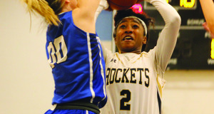 Sophomore guard Kiki McIntyre (2) fights through a double team and puts up a jump shot. 