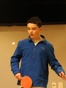 Daniel King keeps his eye on the ball during a game of ping pong.